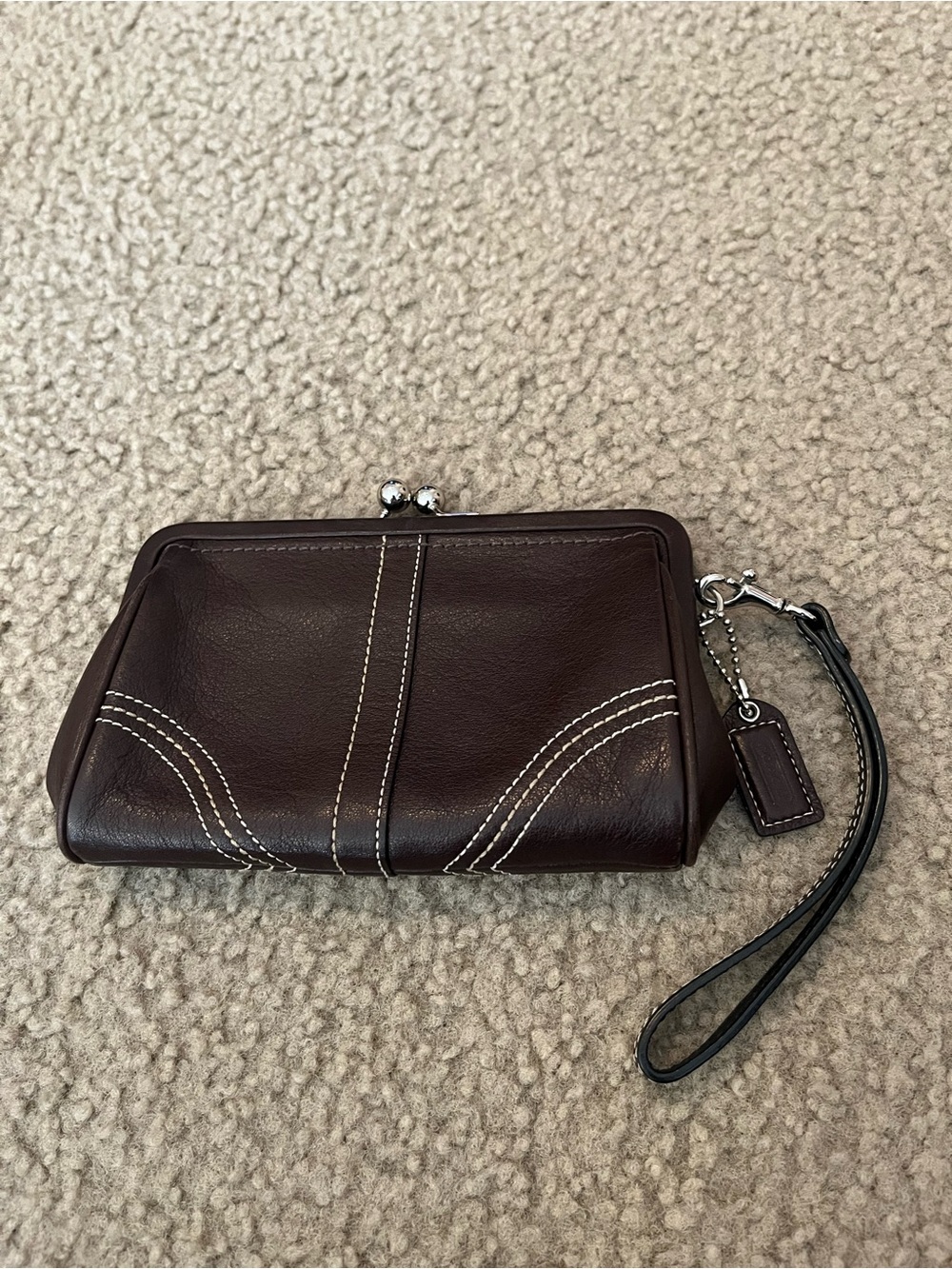 Vintage Coach Kisslock wristlet clutch in dark brown with silver hardware.